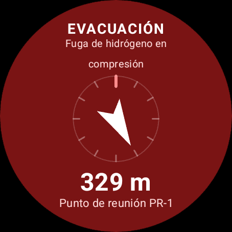 Pantalla de evacuación del reloj: «Fuga de hidrógeno en compresión», una brújula con la flecha al punto de reunión, 329 metros que quedan y el rótulo «Punto de reunión PR-1»